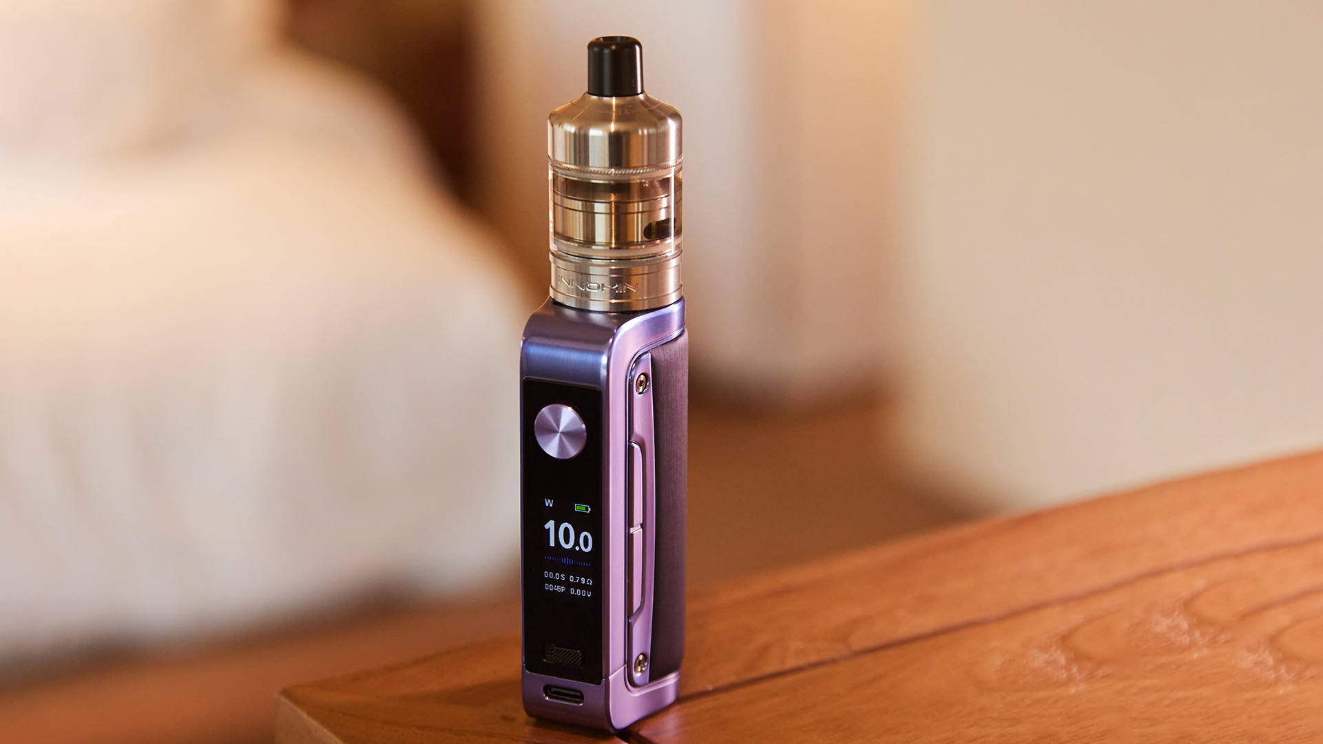Innokin Coolfire Z80 Nex refillable vape device displaying 10.0 watts on a wooden surface.