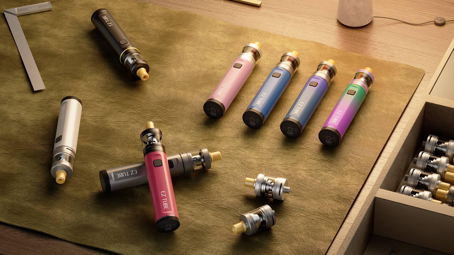 A collection of modern, brightly colored vape pens and detachable coils spread out on a green leather surface, illustrating common troubleshooting scenarios—such as a vape pen not working after charge—amid a well-organized workspace.