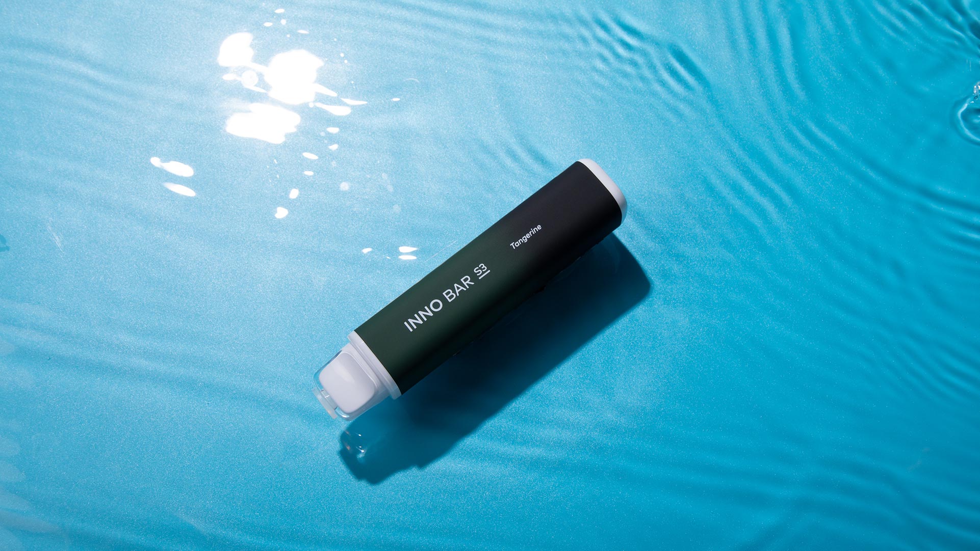 Disposable vape floating on water, emphasizing the water-based e-liquid benefits.